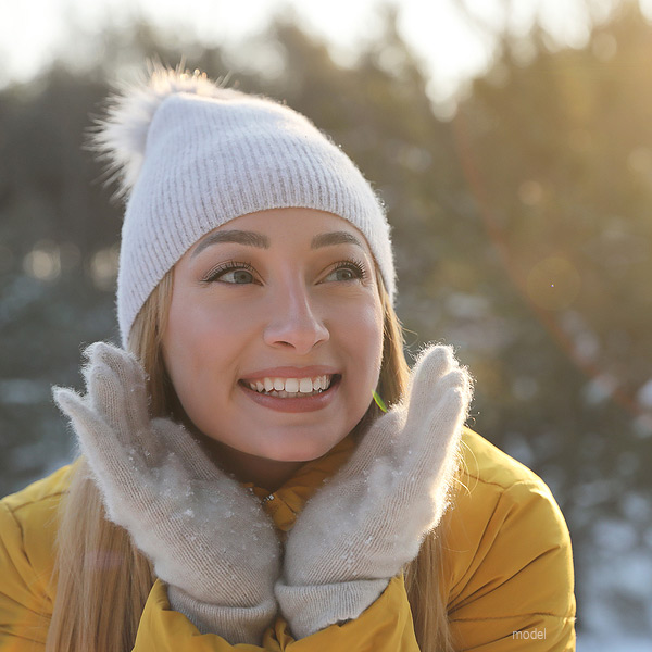 Woman in hat and gloves with beautiful skin, demonstrating how a customized natural experience at Chicago's Iteld Aesthetics Institute can work for you.